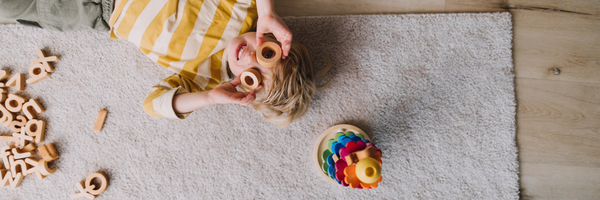 child playing with wooden toys