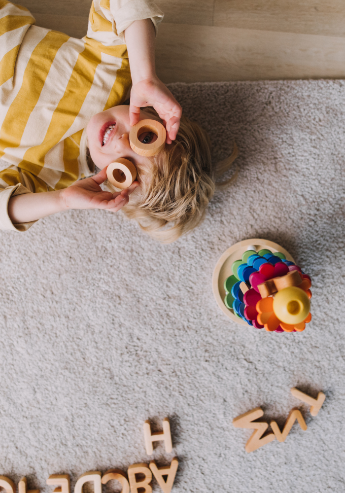 child playing with wooden toys